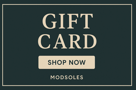 ModSoles digital gift card with cream text on dark teal background featuring ‘Gift Card’ and ‘Shop Now’ button