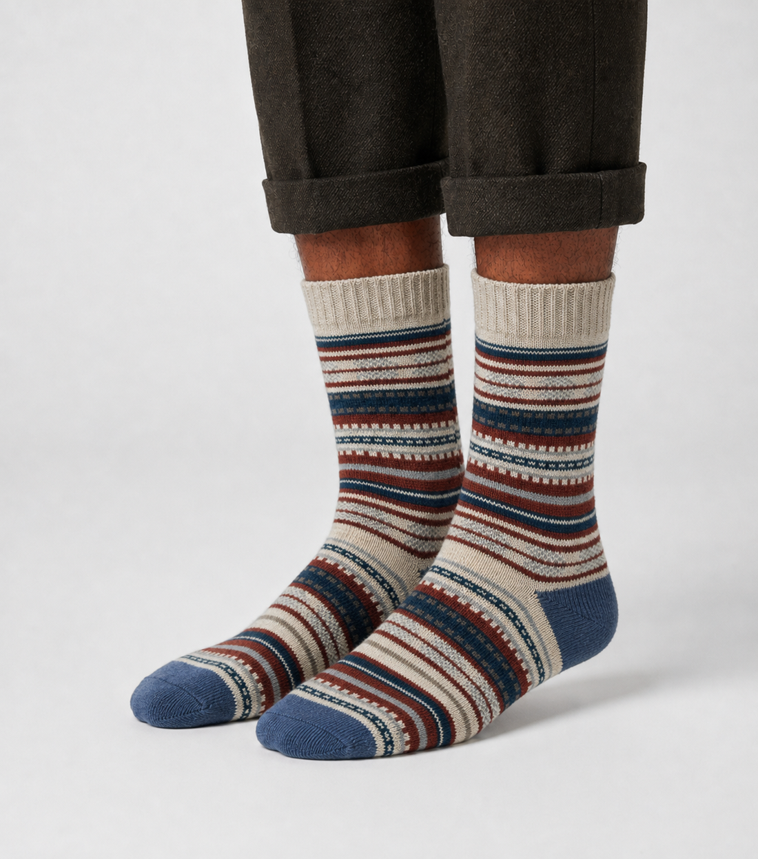 Sierra Loom socks flat lay showing cool blue and earthy red mountain-inspired heritage knit